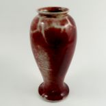 A Ruskin Pottery vase, of baluster form, decorated in a red lustre glaze, dated 1924,