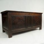 An antique oak coffer, having three carved panels to the front, the centre dated 1677,