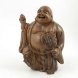 A terracotta model, of a Buddha, with foot raised, holding items in his hand, signed to reverse,