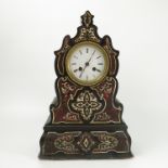 A 19th century French mantel clock, the shaped lacquered case decorated with a boule inlay,