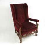 A 17th century style armchair, raised on part cabriole legs,