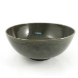 A Ruskin pottery bowl, decorated with a dark green glaze, with oval and scissor mark, dated 1905,