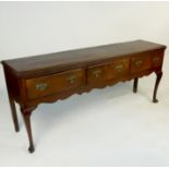 A late Georgian oak dresser base, fitted three frieze drawers,