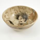 A Japanese Satsuma bowl, decorated to the interior with male figures and the exterior with flowers,