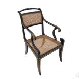 An ebonised parcel gilt bergere chair, in the Regency style,