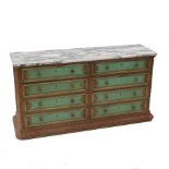A green painted chest, having a marble top fitted with two banks of four long drawers to each side,