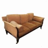 An Empire style sofa, of elongated lyre form with gilt roundels and short reeded legs,