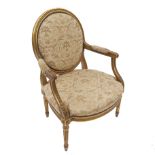 A pair of giltwood arm chairs, with oval backs, reeded arms with acanthus leaves,