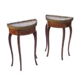 A pair of half round side tables,