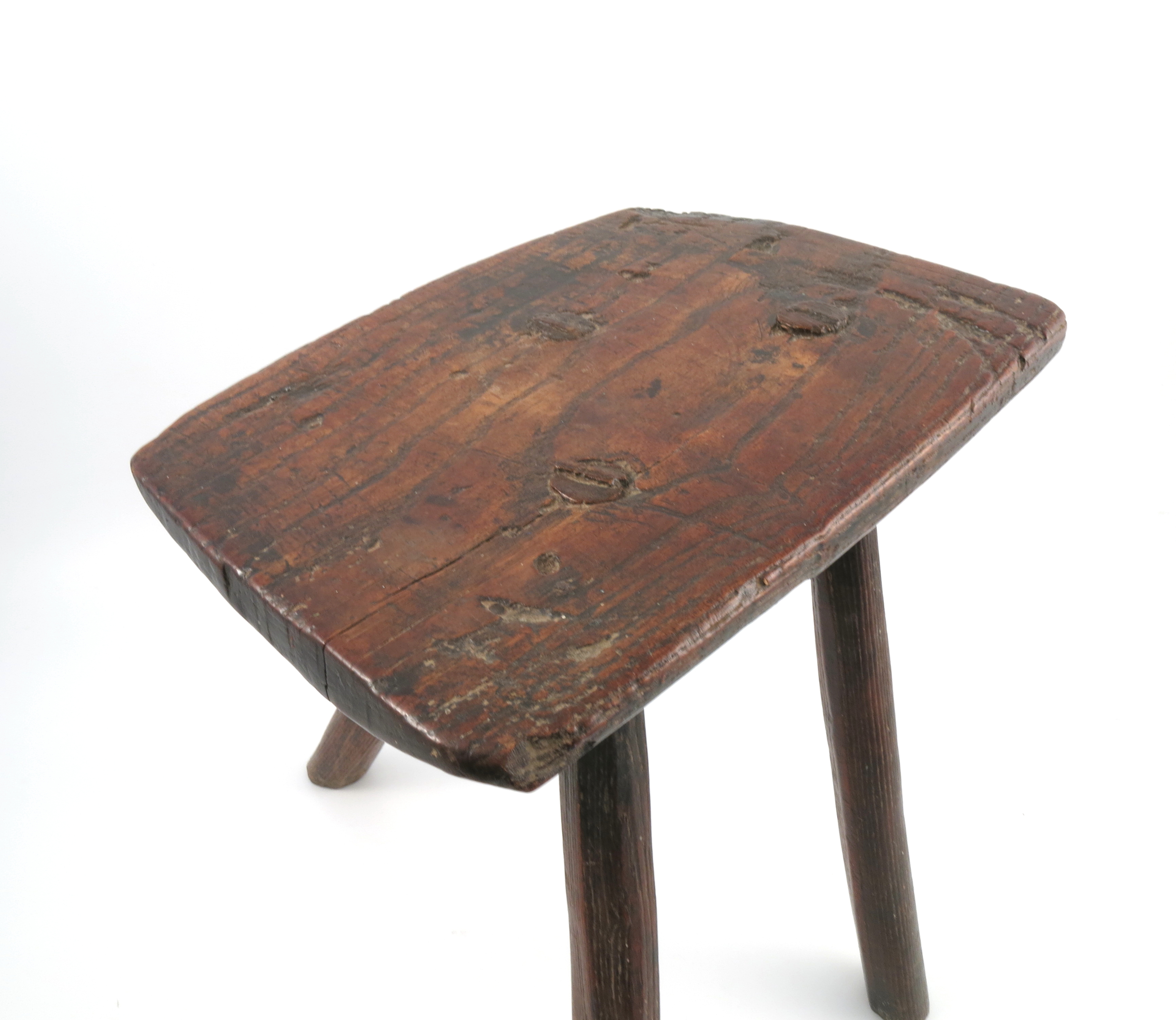 An Antique primitive stool, the rectangular top raised on three legs, 14ins x 9ins x 16. - Image 2 of 3