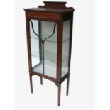 An Edwardian mahogany display cabinet, with glazed door and sides with burr walnut lined inlay,