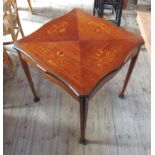 An Edwardian centre table, having marquetry decoration, raised on four square tapering legs,