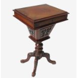 A 19th century walnut work table, with rising lid raised on turned column with four outswept legs,