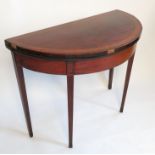 A late Georgian mahogany half round fold over tea table, with satinwood crossbanding,