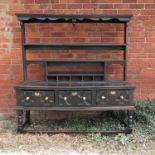 An antique oak dresser, with open Delft rack over, having moulded front shelves to the base,