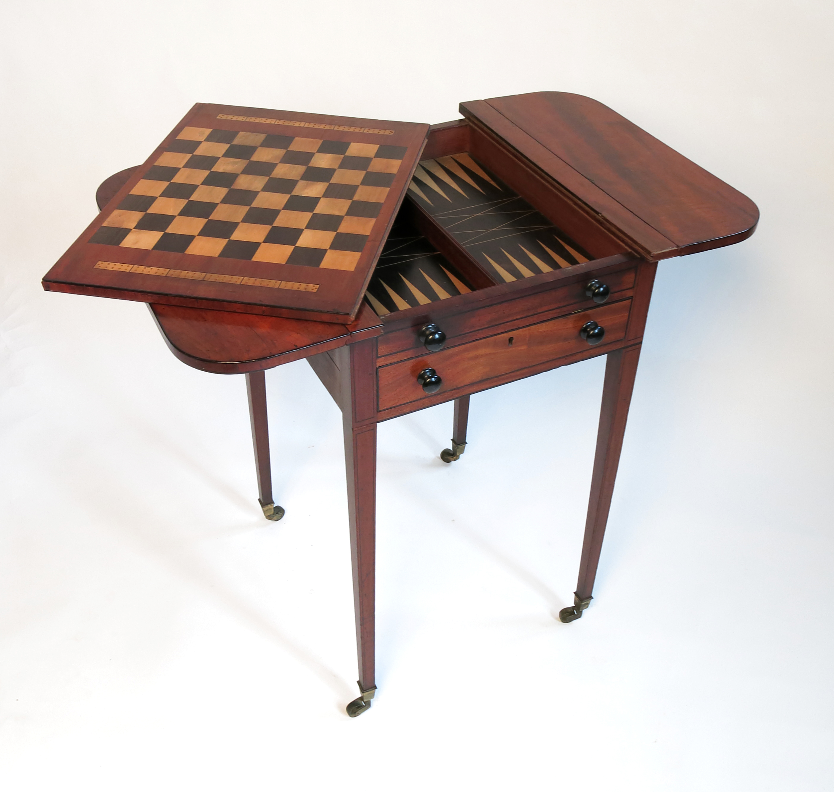 A late Georgian mahogany Pembroke games table, the slide out reversible top with draughts board,