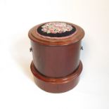 A Victorian mahogany circular commode, with needle point seat and lift out chamber pot,