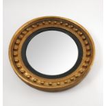 A 19th century circular convex wall mirror, the gilt frame with applied ball decoration,