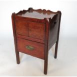 A 19th century mahogany tray top commode, having two cupboards below a slide out drawer,