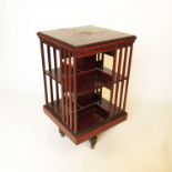 A two tier Edwardian rosewood revolving bookcase,