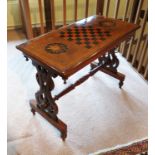 A 19th century mahogany rectangular centre table, inlaid with a games board and broad line inlay,