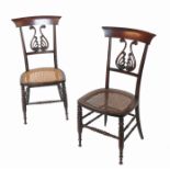 A set of four 19th century rosewood salon chairs, with lyre shaped backs,