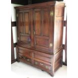 An 18th century oak press cupboard, one pair of doors with fielded panels,