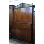 A 19th century mahogany secretaire bookcase, having two blind doors below an architectural frieze,