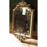 A gilt framed wall mirror, with rebated arched top,