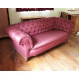 A Victorian Chesterfield settee, on turned front supports,