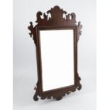 A mahogany framed fret cut mirror, in the Georgian style with scrolling edge,