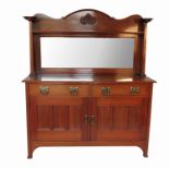 An Art Nouveau sideboard, with rectangular mirror back, with carved frieze and columns over,