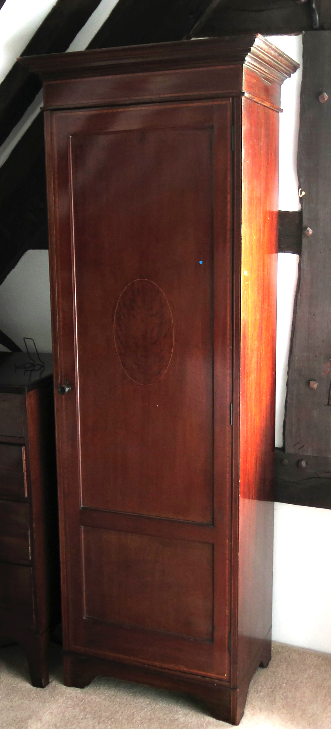 An Edwardian mahogany single door wardrobe, with satinwood and ebonised inlay,