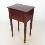 A small 19th century mahogany bedside pot cupboard, raised on turned legs,