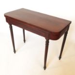 A 19th century mahogany foldover card table, raised on four turned legs, width 36.