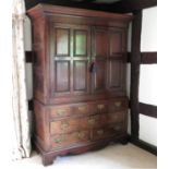 An antique oak linen press, the top fitted with two doors with fielded panels,