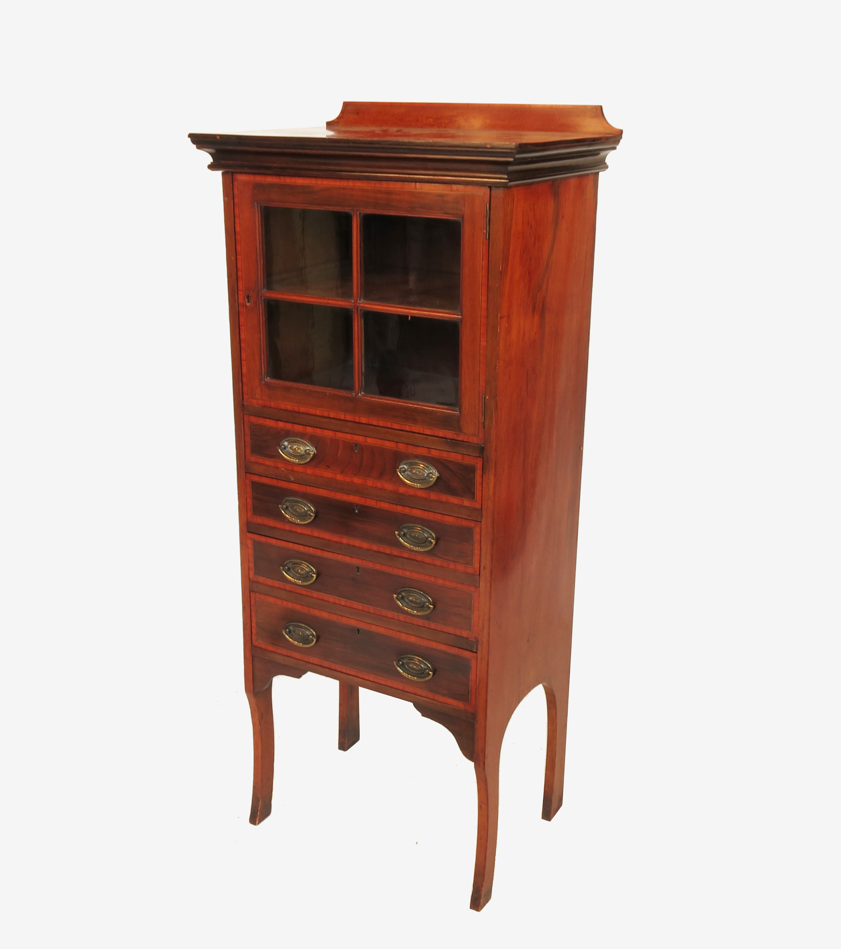 An Edwardian mahogany music cabinet, having a glazed cupboard over four cross banded drawers,