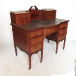 A late 19th century break bow fronted writing desk,