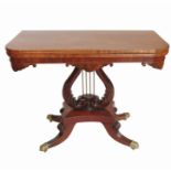 A 19th century fold over tea table, raised on a carved wooden lyre shaped support with brass rods,