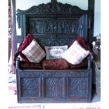 An antique oak box seat hall settle,