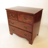 A small mahogany chest, of two short drawers over two long drawers, raised on bracket feet,