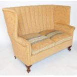 A Georgian design high back sofa, raised on short cabriole legs,