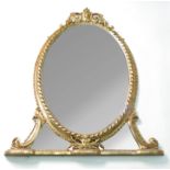 A gilt framed oval wall mirror, with scrolls, leaves and flower heads to the pediment,