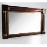 A 19th century rosewood framed wall mirror, the frame decorated with half columns,