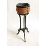 A 19th century circular ebonised jardinere stand, with a band of pollard oak,