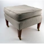 A late 19th century Howard and Sons square ottoman footstool, on square tapering mahogany legs,