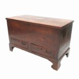 An elm mule chest, with plain rising lid and fitted with two drawers below, raised on bracket feet,