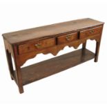 An Antique oak pot board dresser, fitted with three drawers in a shaped apron,