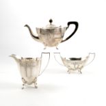 A silver three piece tea set, of shaped oval form,