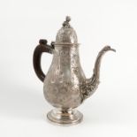 An Italian silver coffee pot, of baluster form, the body ornately decorated with flowers and leaves,